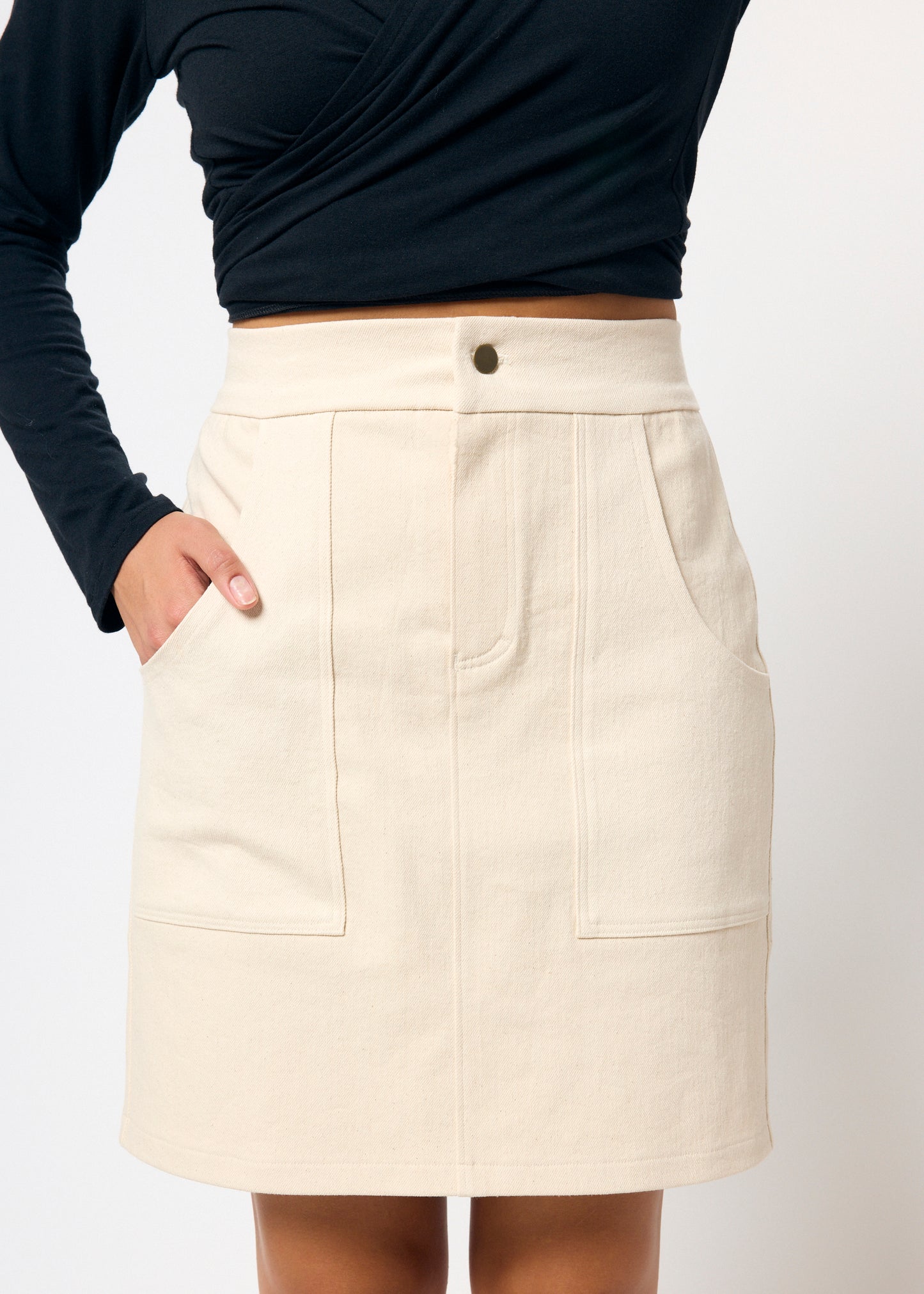 Beige skirt worn by a person with a white background