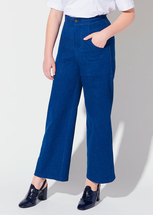 Person wearing blue pants and a white shirt on a white background