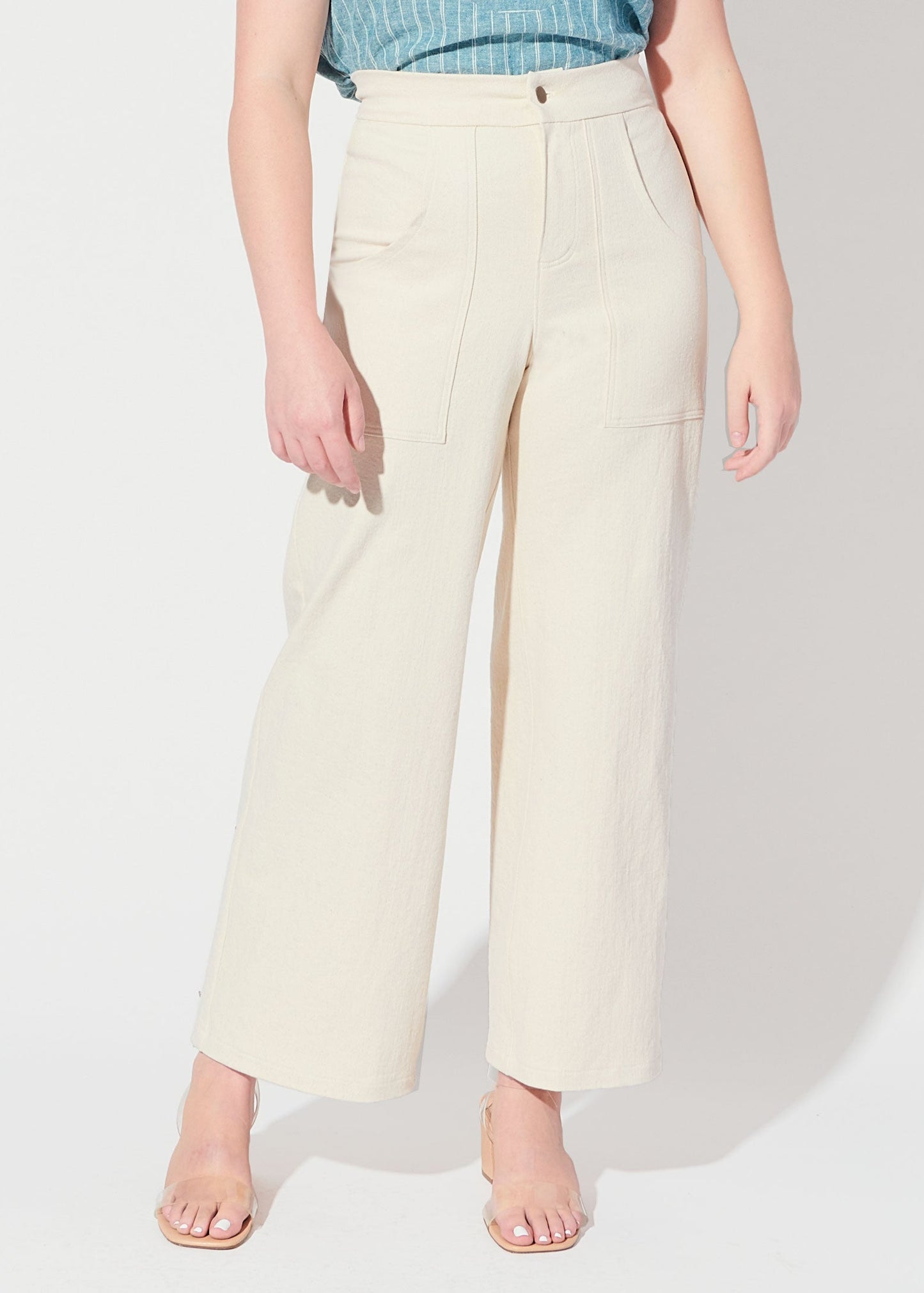 Person wearing light-colored wide-leg pants on a plain background
