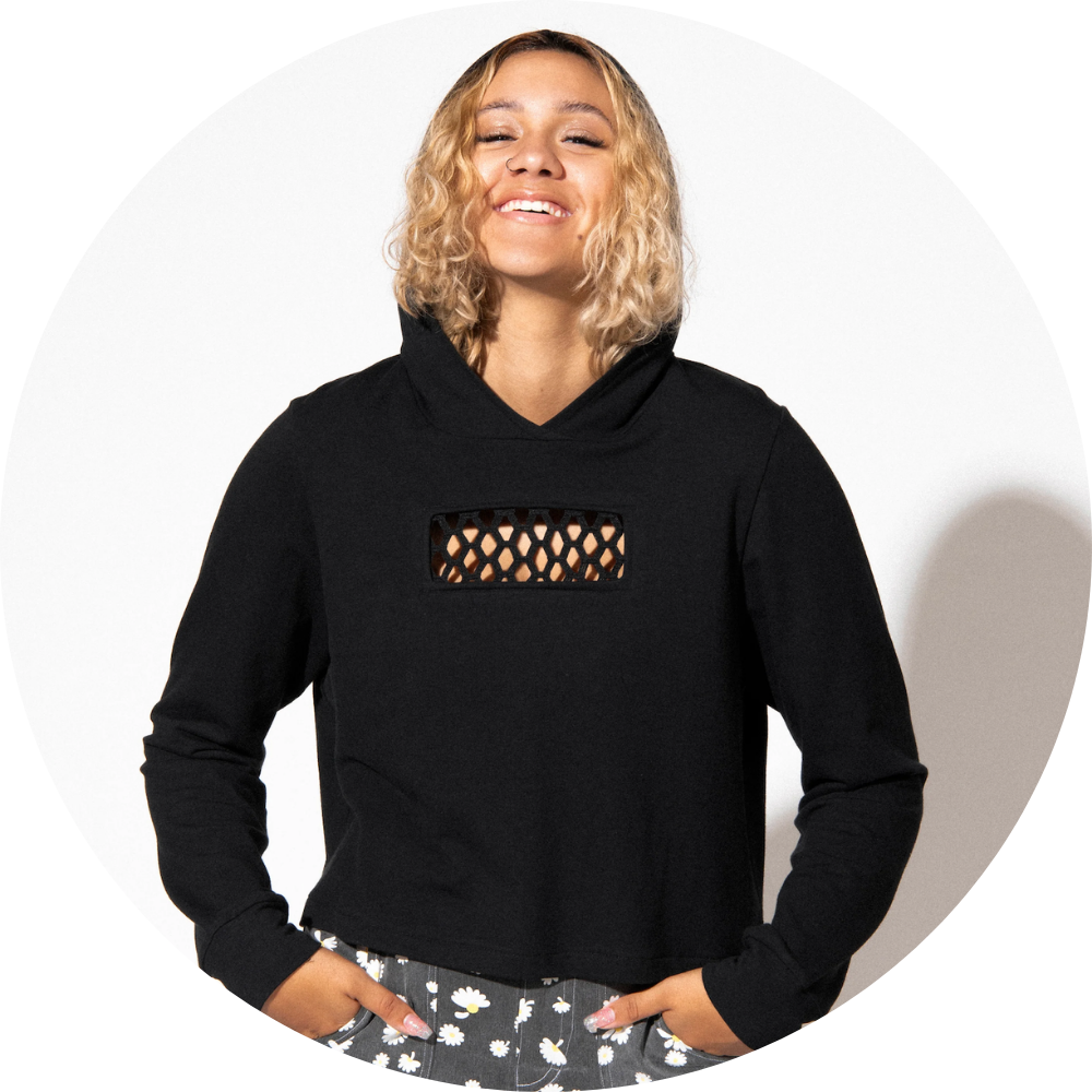 Woman standing wears black hoodie with mesh panel