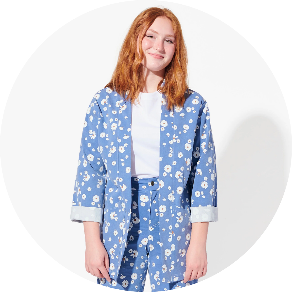 Woman with red hear wears blue floral jacket
