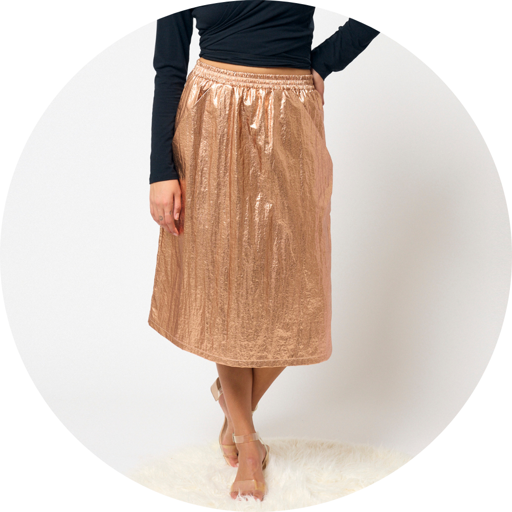 Woman wears bronze colored skirt