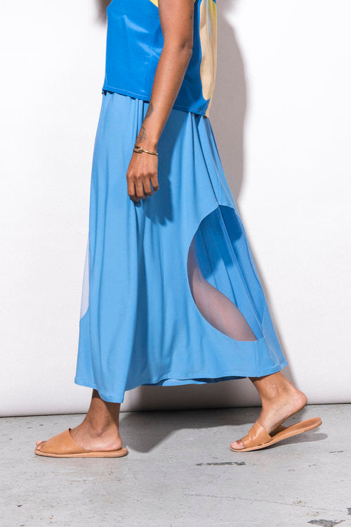 Person wearing a blue dress with a white background