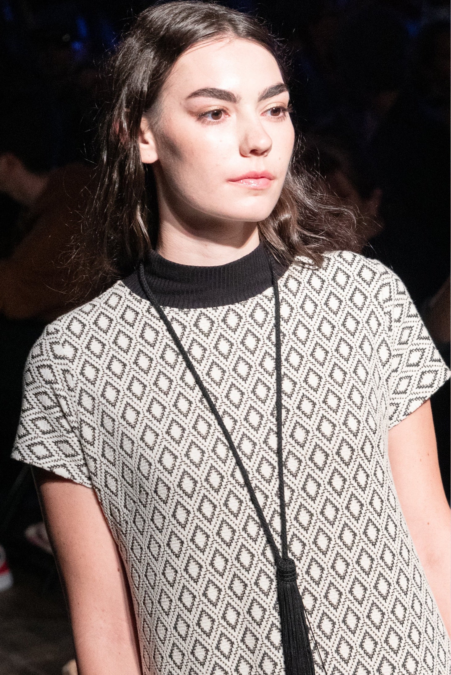 Woman wearing a patterned dress with a blurred background
