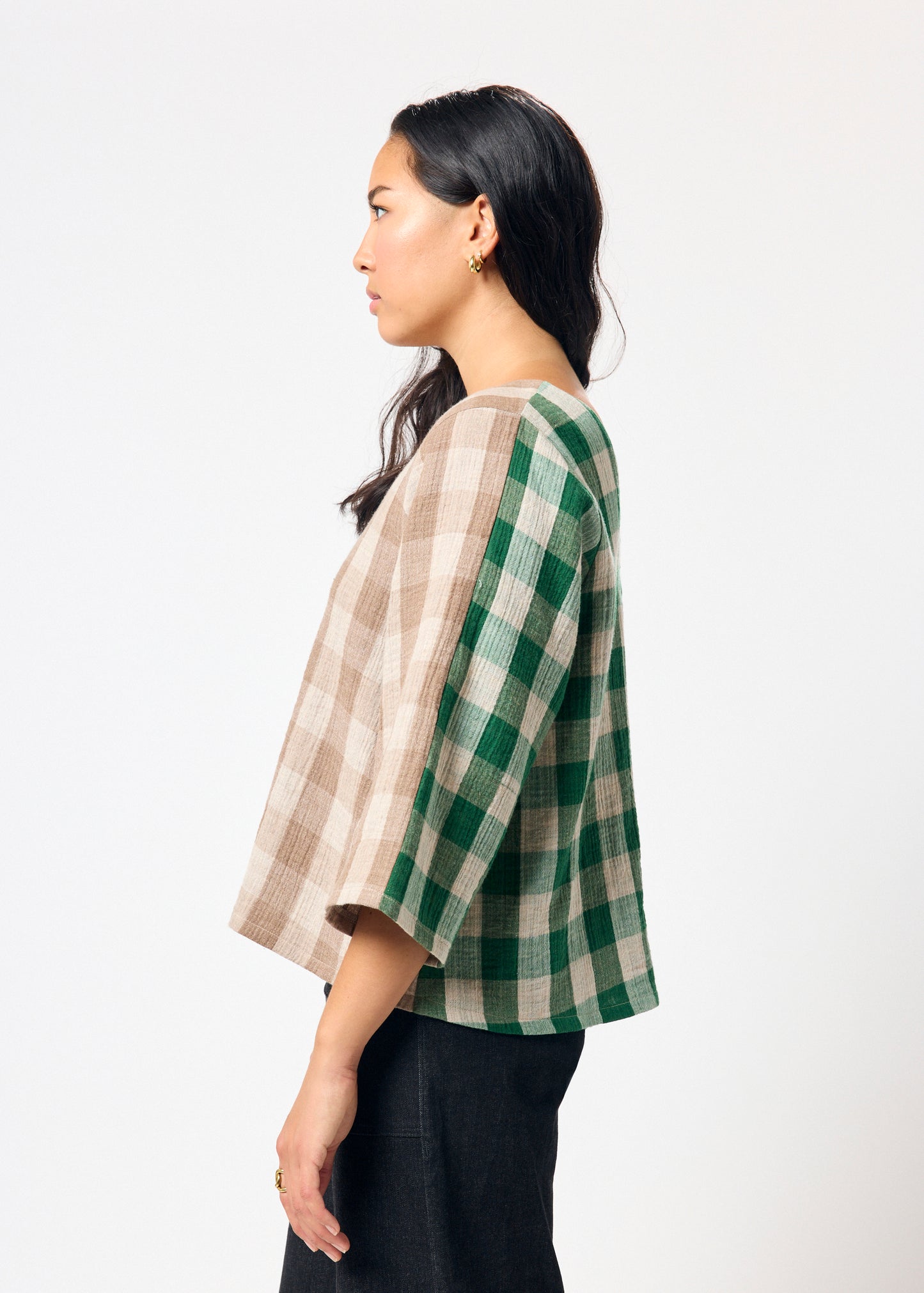 Woman wearing brown and green checkered shirt