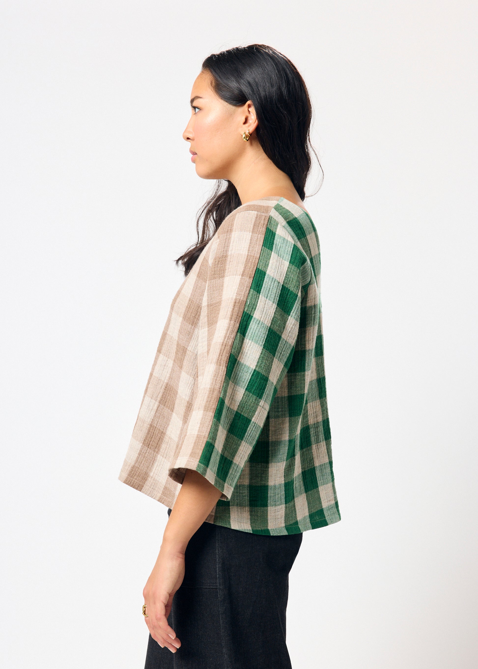 Woman wearing brown and green checkered shirt