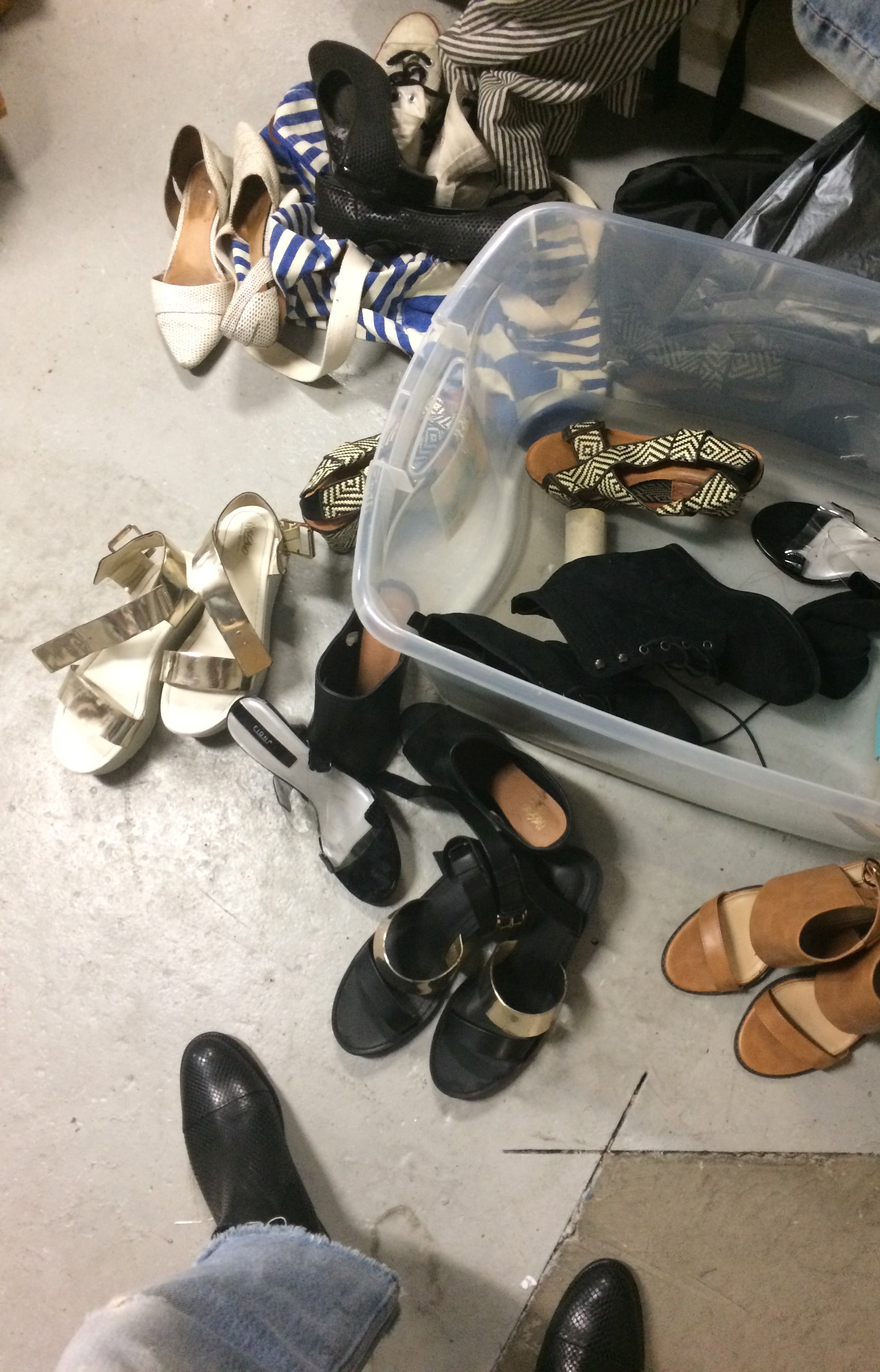 bin on the floor full of high heeled shoes