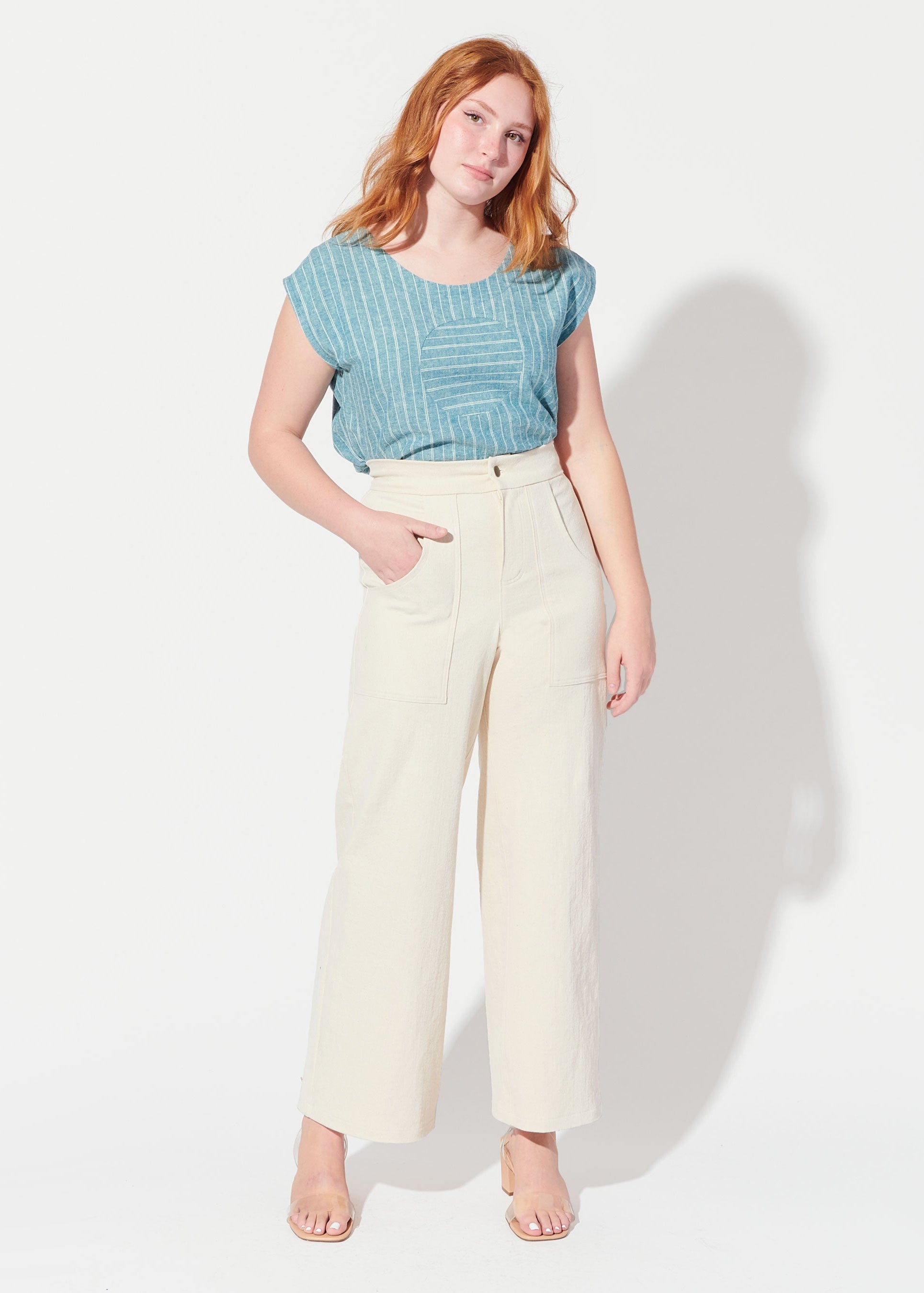 woman wearing blue shirt and cream colored pants