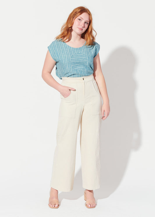woman wearing blue shirt and cream colored pants