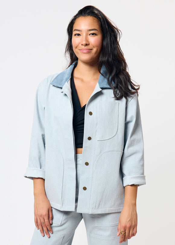 Woman wearing light blue denim jacket with corduroy collar