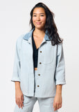 Woman wearing light blue denim jacket with corduroy collar