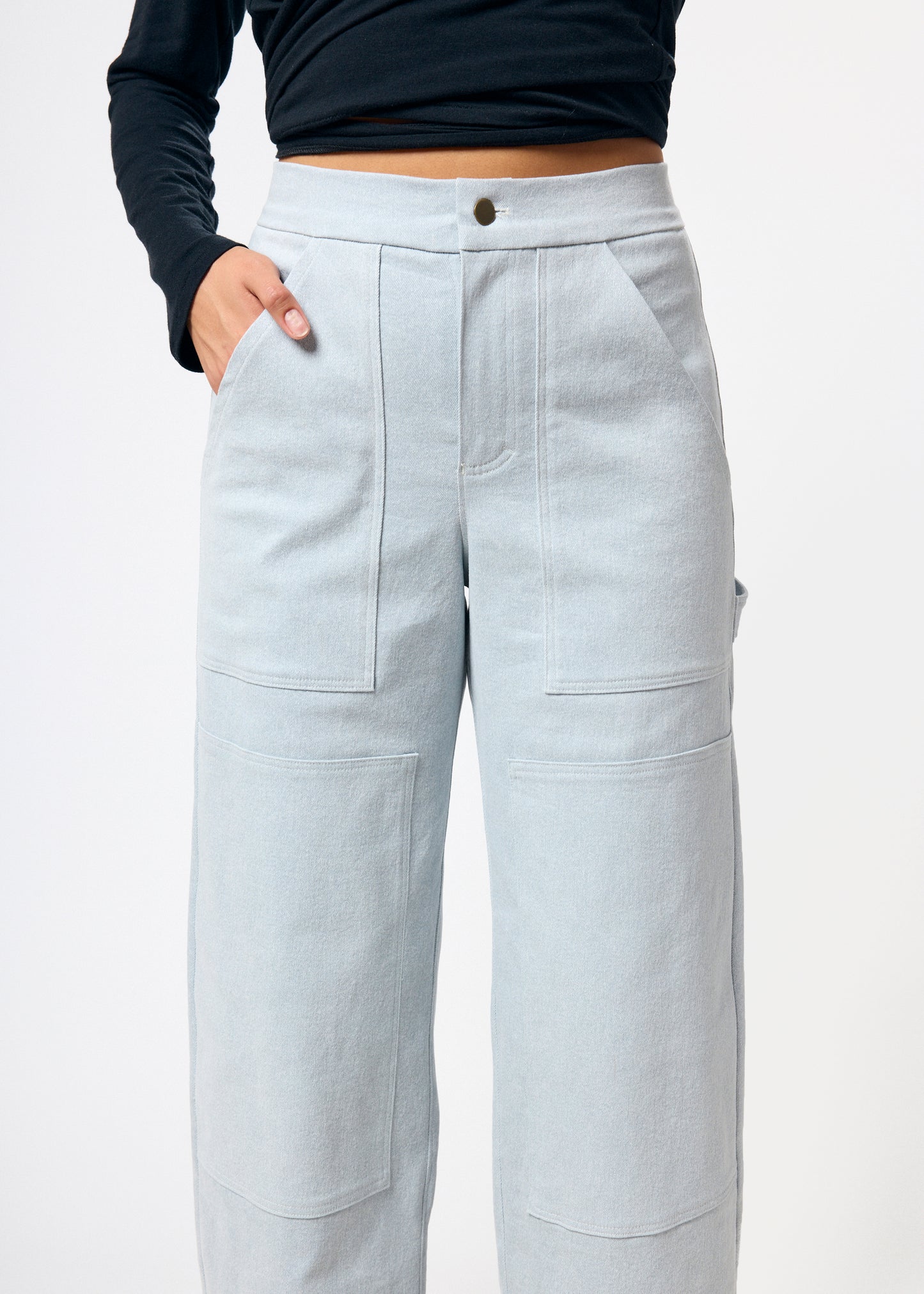 Light gray pants worn by a person on a white background