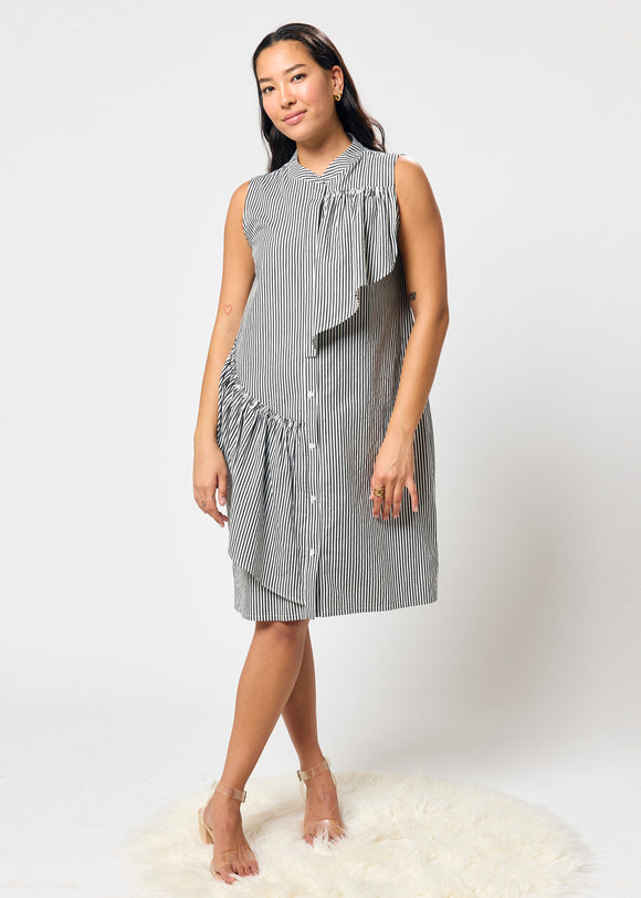 Woman wearing a sleeveless striped dress on a white background