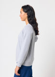 Woman wearing a gray sweatshirt on a white background