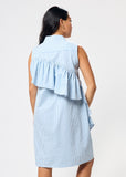 Woman wearing a light blue and white striped dress with ruffled layers on a white background