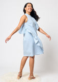 Woman wearing a blue and white striped dress with ruffled layers on a white background